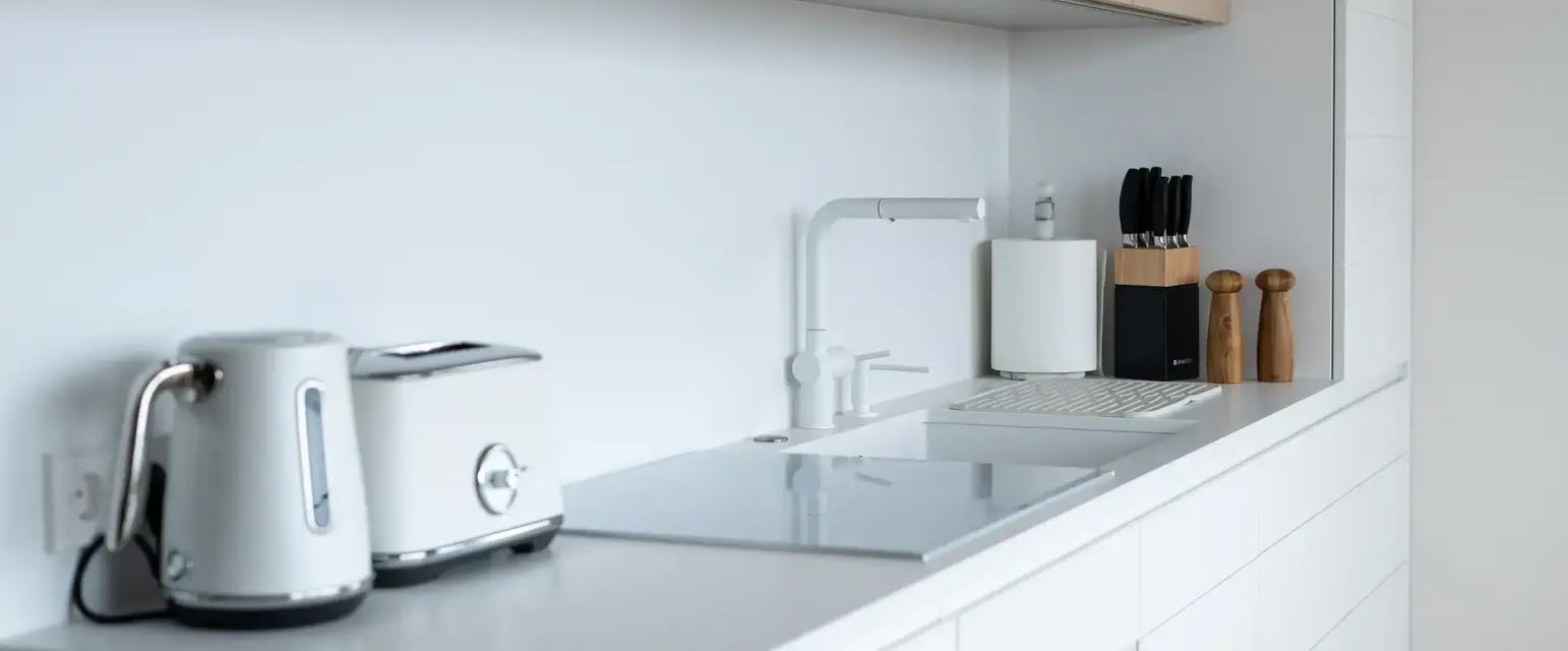 a kitchen counter with a toaster and a laptop