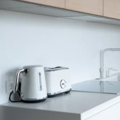a kitchen counter with a toaster and a laptop