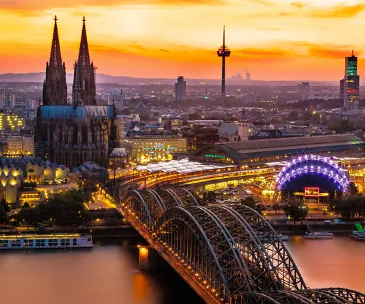 a bridge over a river with a large building and a bridge