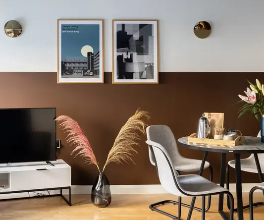 a room with a table and chairs and a television