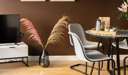 a room with a table and chairs and a television