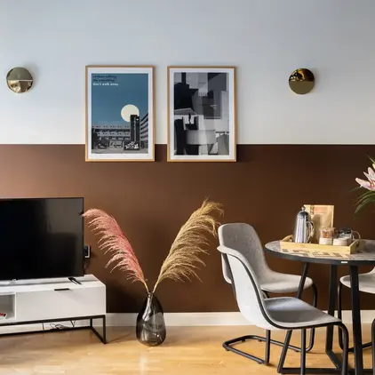 a room with a table and chairs and a television