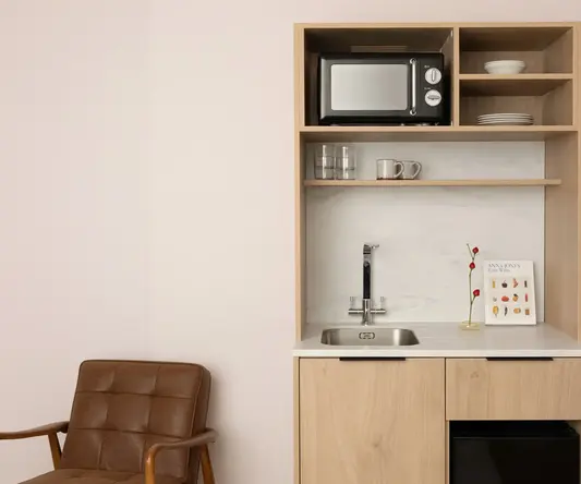 a kitchen with a microwave and a sink