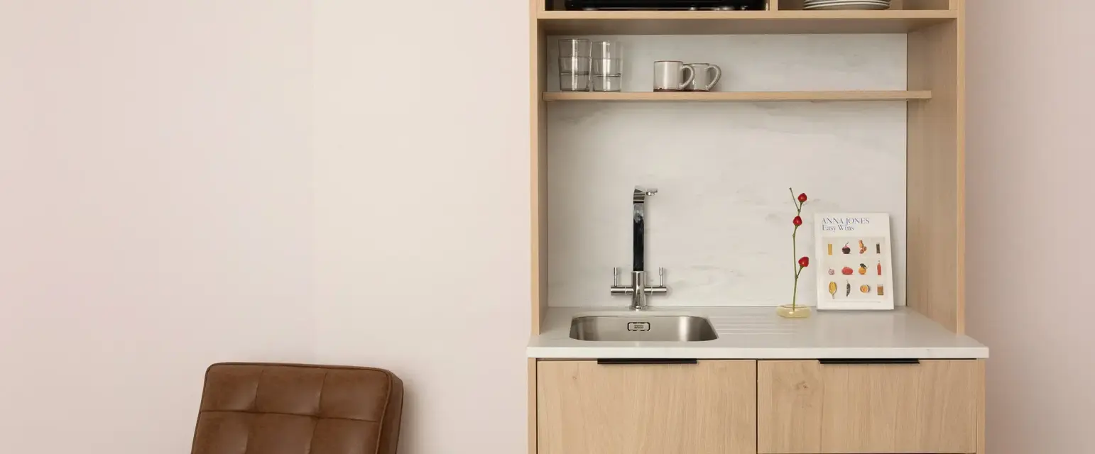 a kitchen with a microwave and a sink