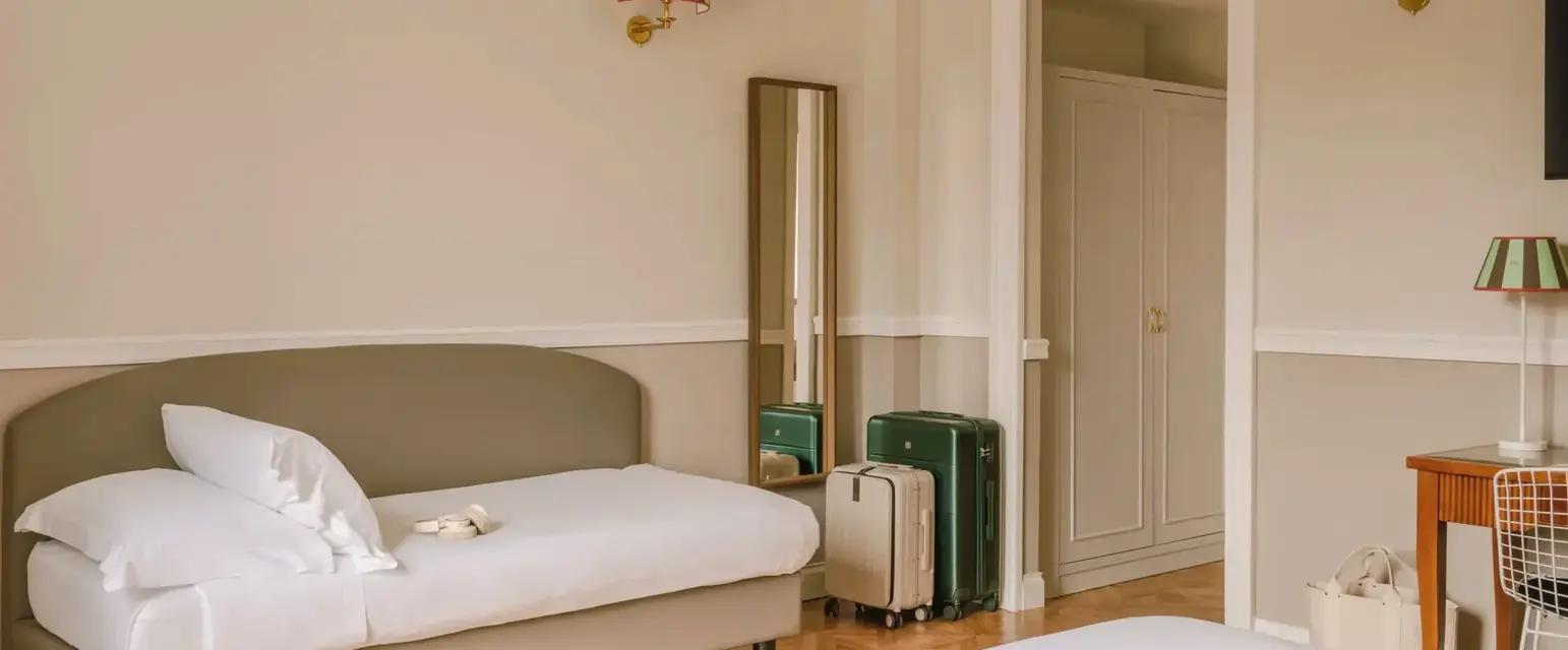 a room with a bed and luggage