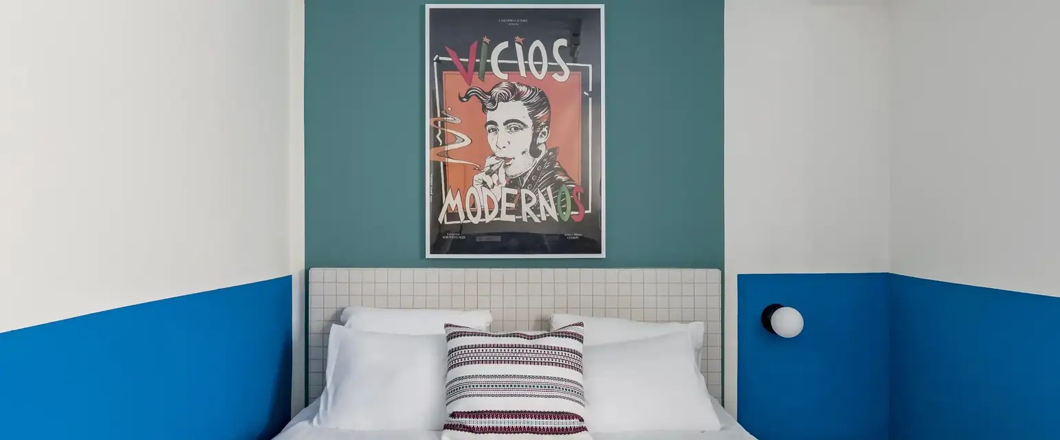 a bed with white sheets and towels on it