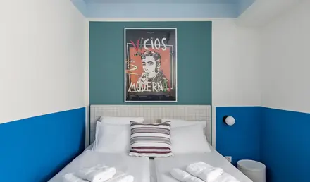 a bed with white sheets and towels on it