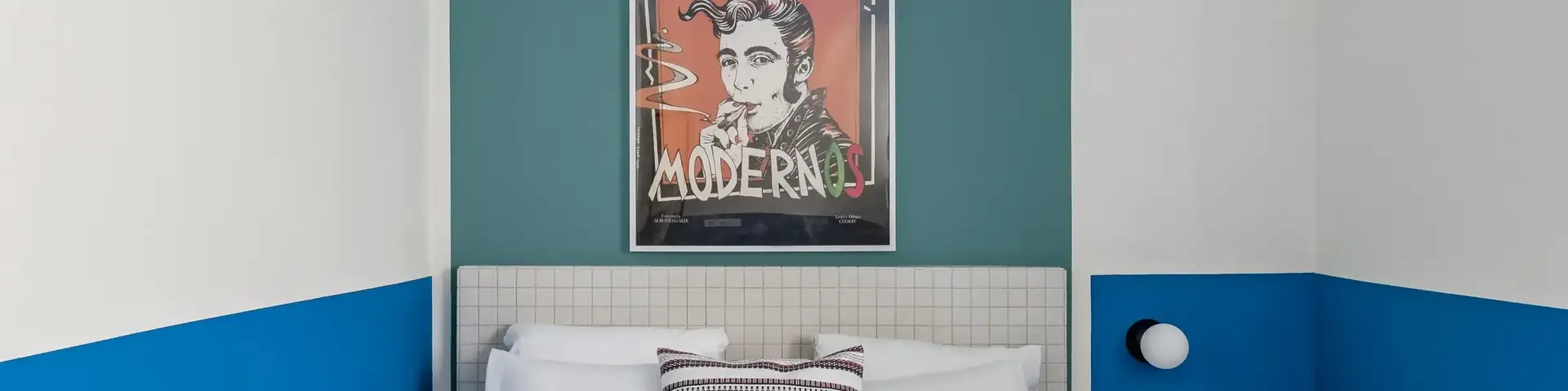 a bed with white sheets and towels on it