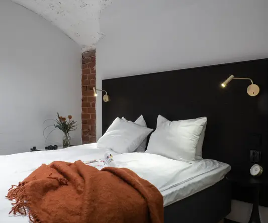 a bed with pillows and a blanket