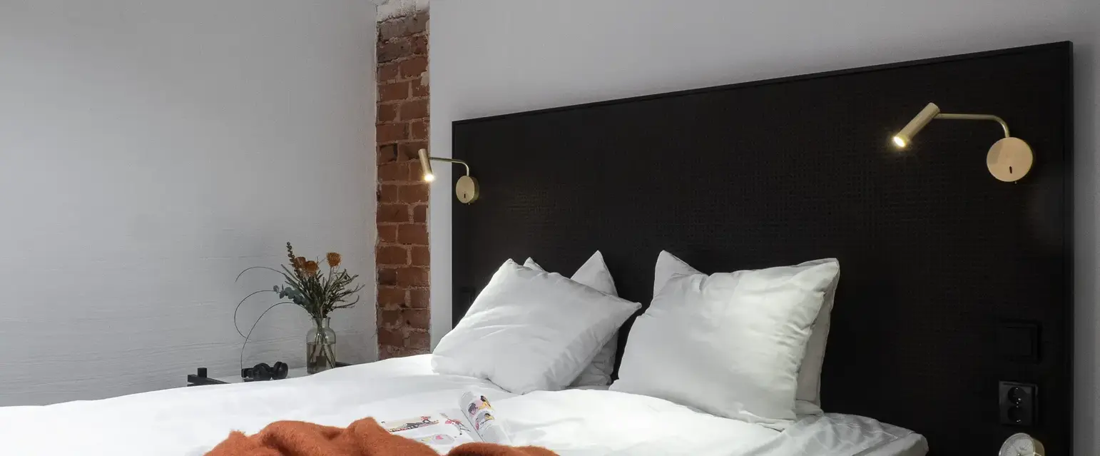 a bed with pillows and a blanket