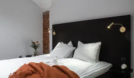 a bed with pillows and a blanket