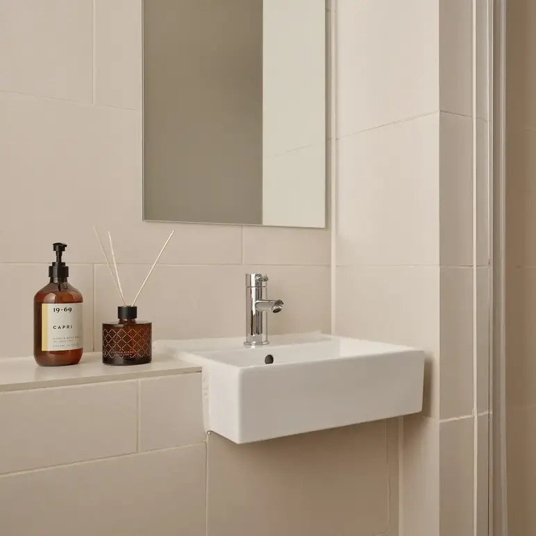 a bathroom with a mirror and sink