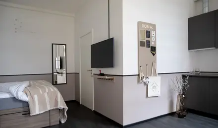 a room with a tv on the wall