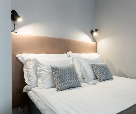 a bed with pillows and a headboard