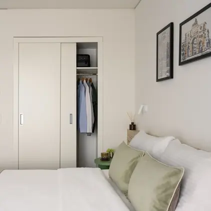 a bedroom with a closet and a bed
