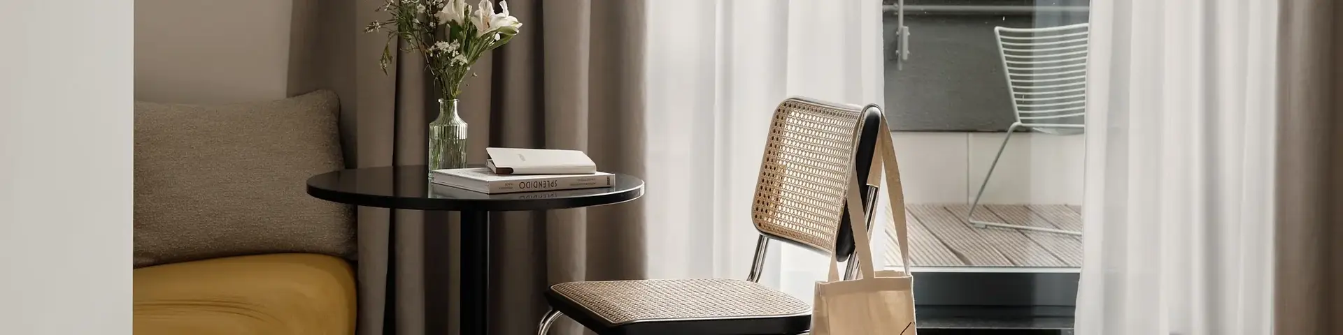 a room with a table and chairs and a bed and a balcony