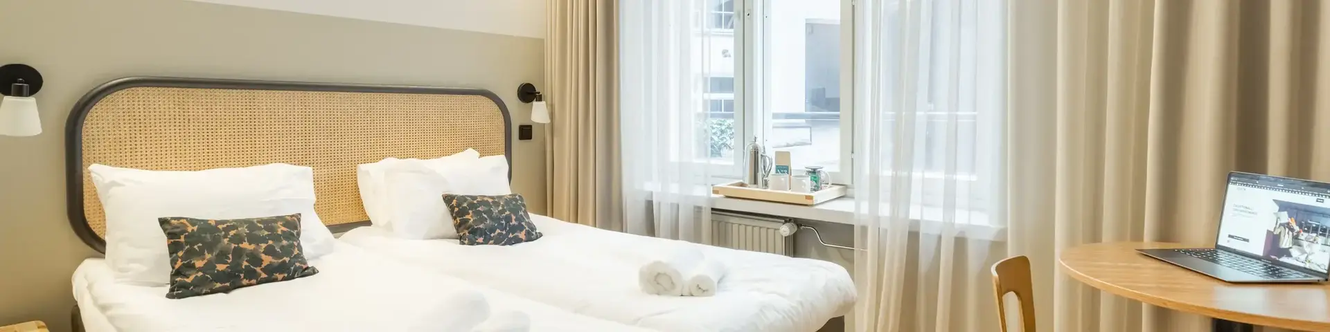 a bedroom with a table and two beds