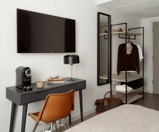 a room with a tv and a desk