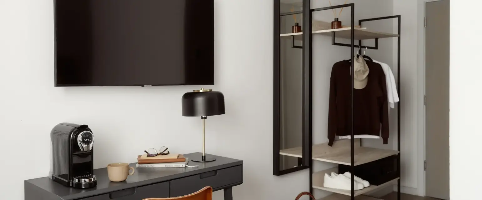 a room with a tv and a desk