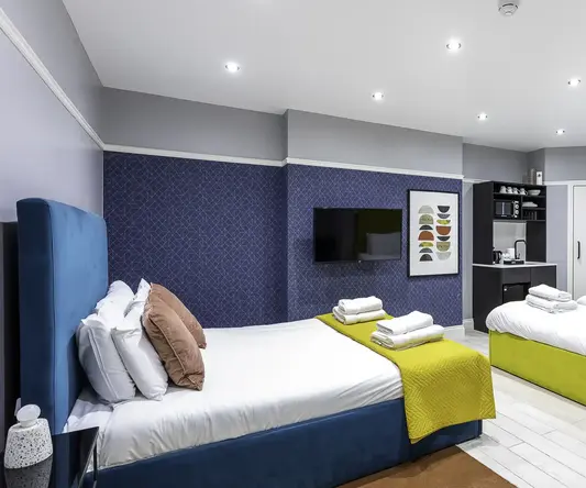 a room with two beds and a tv