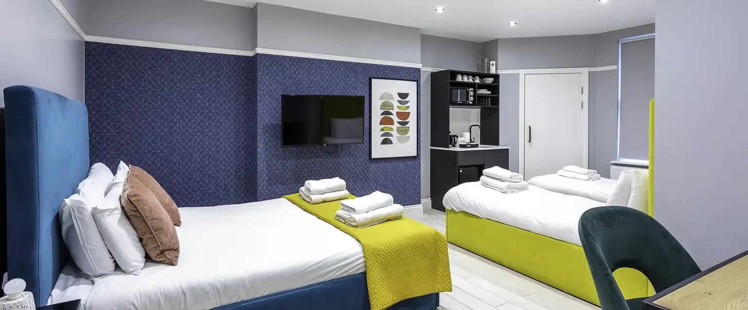 a room with two beds and a tv