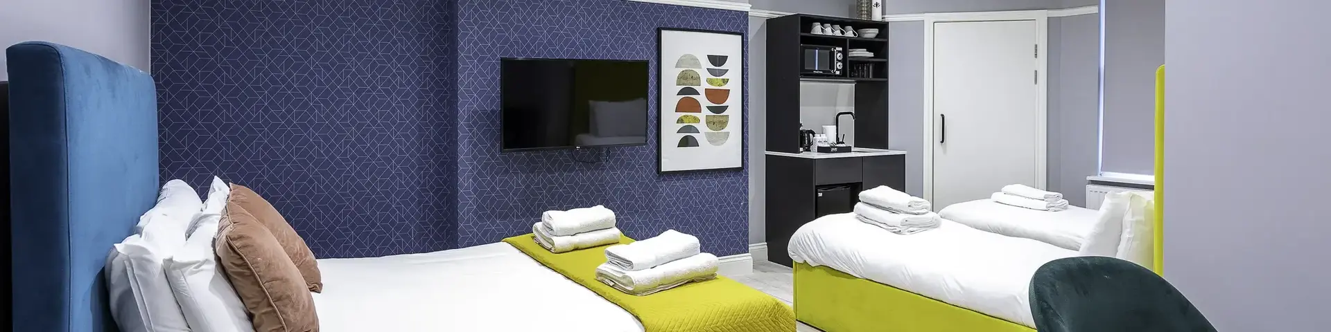 a room with two beds and a tv