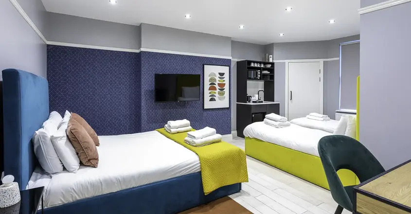 a room with two beds and a tv