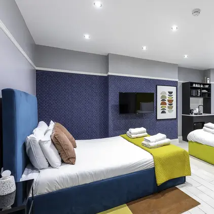 a room with two beds and a tv