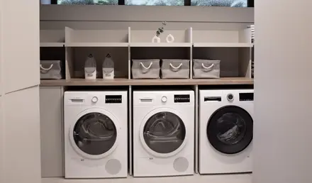 a laundry room with white appliances