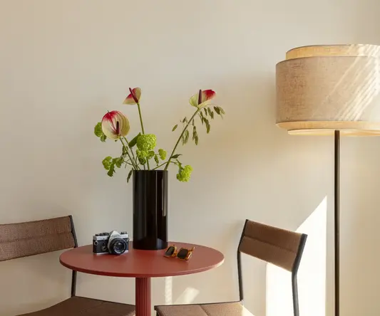 a vase with flowers on a table