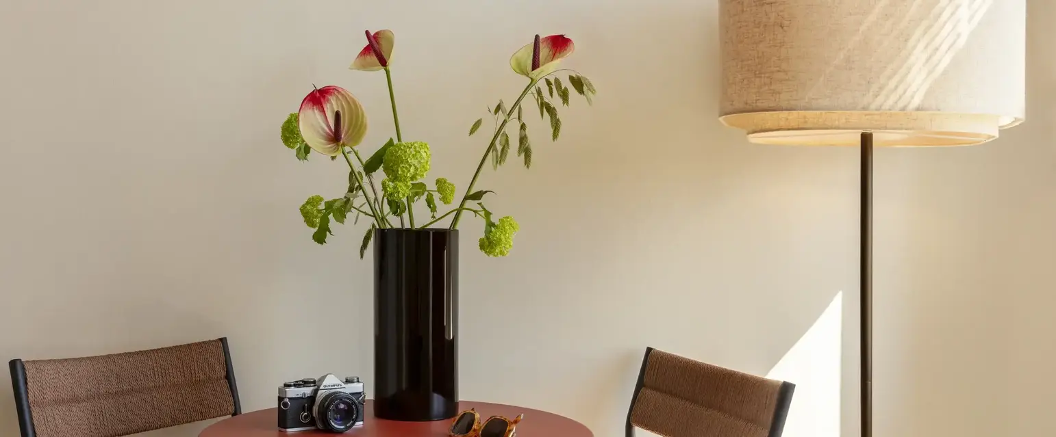 a vase with flowers on a table