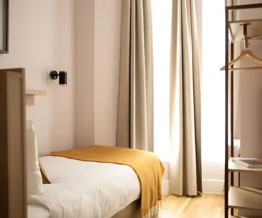 a room with a bed and a shelf