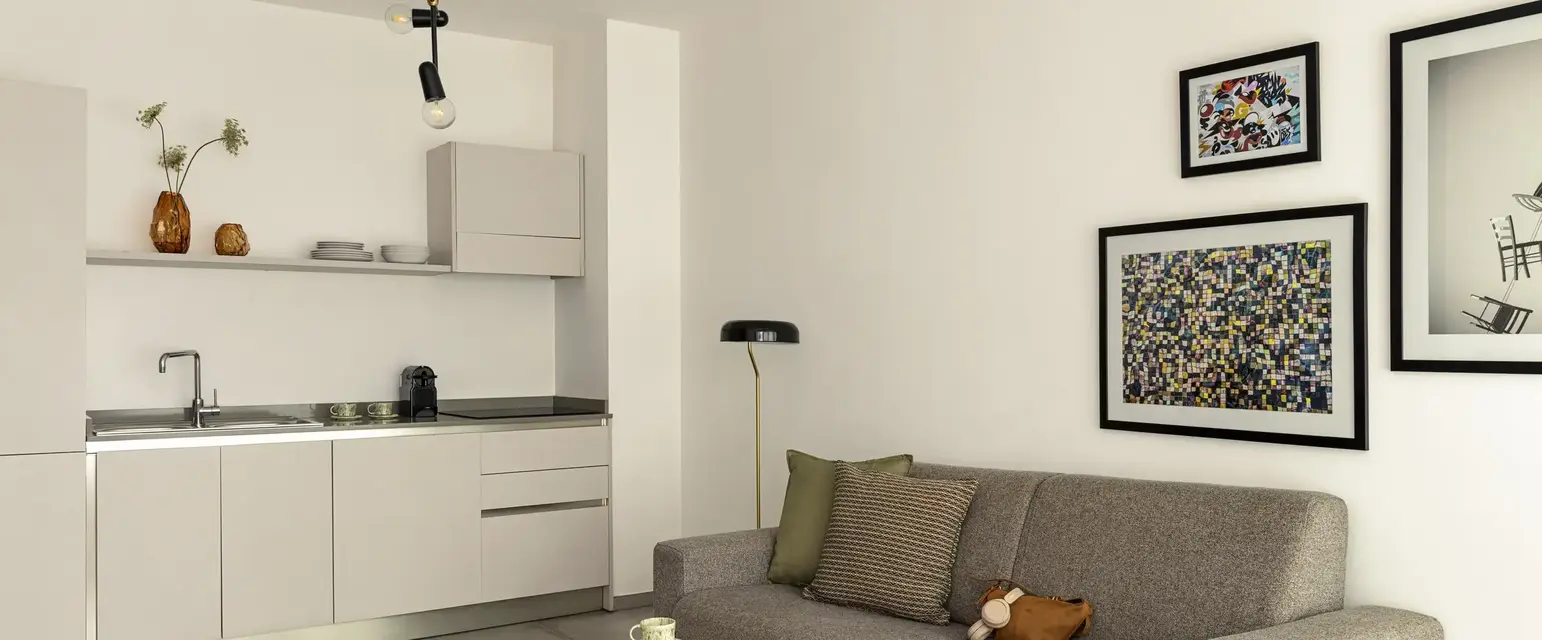 a living room with a couch and kitchen