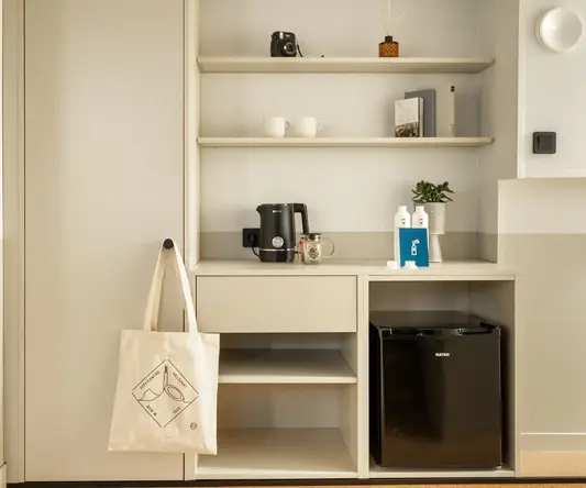 a white shelf with shelves and a coffee maker