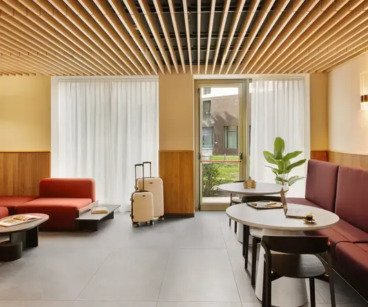 a room with chairs and tables and luggage