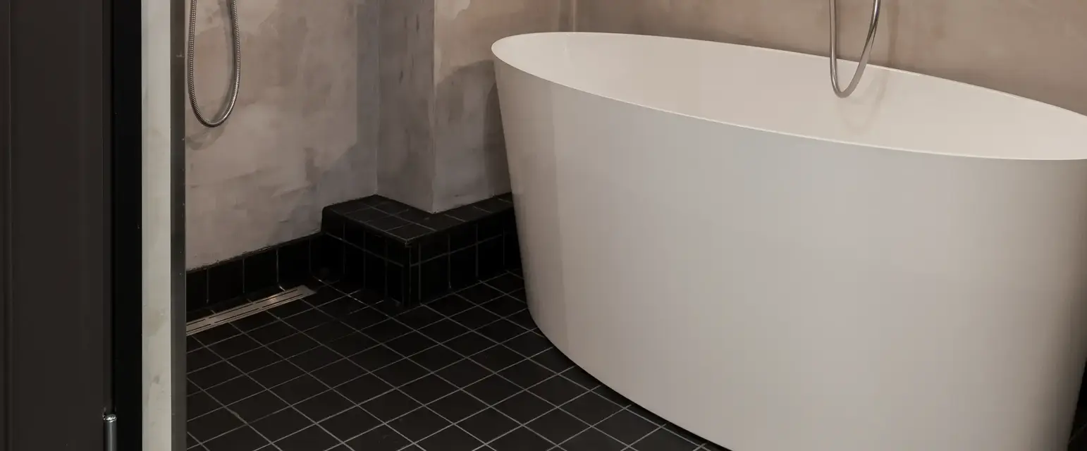 a bathroom with a tub shower and shower head