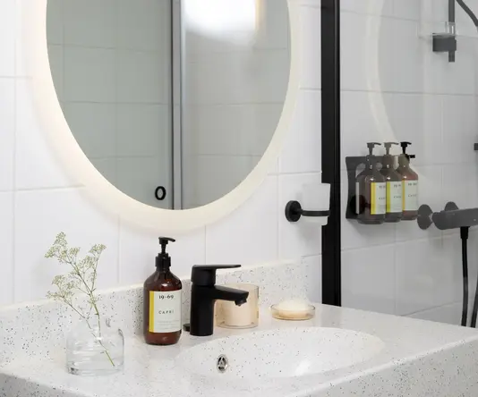 a bathroom with a mirror and a shower