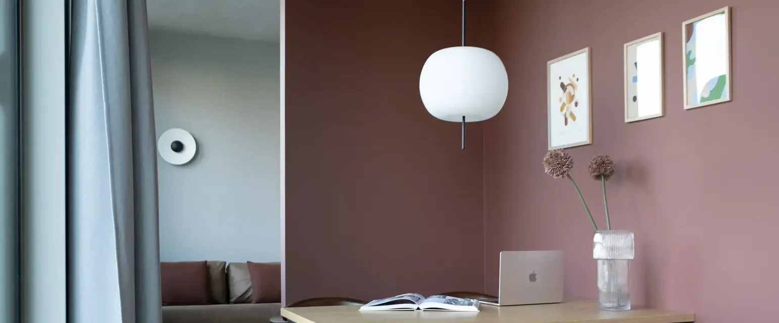 a table with chairs and a laptop on it