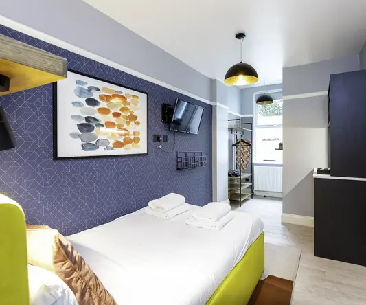 a room with a bed and a television