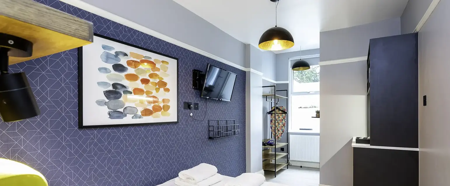 a room with a bed and a television