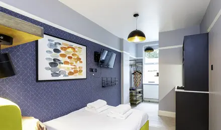 a room with a bed and a television