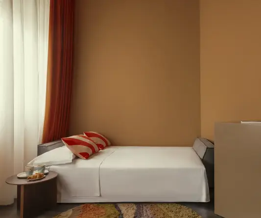 a bed with a red flower in a room