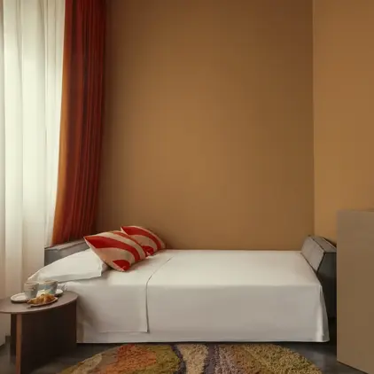 a bed with a red flower in a room