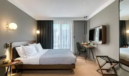 a bedroom with a bed and a tv