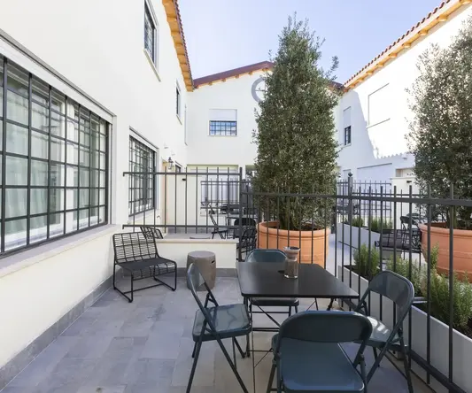 a patio with a table and chairs