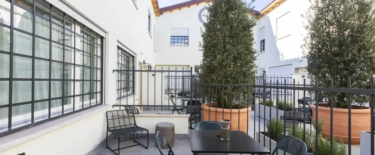a patio with a table and chairs