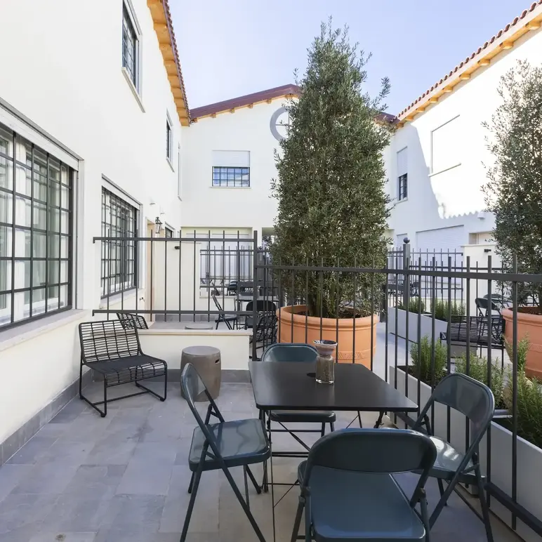 a patio with a table and chairs