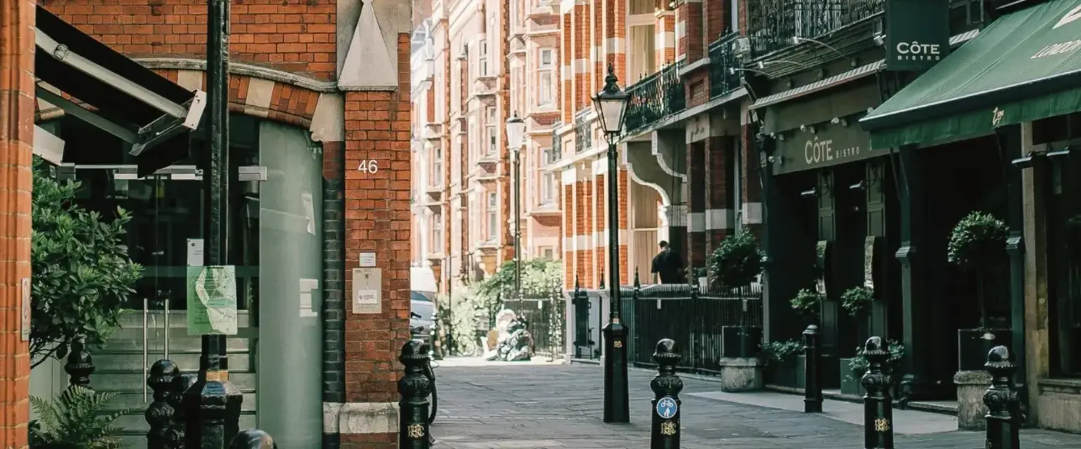 a street with brick buildings and a street lamp