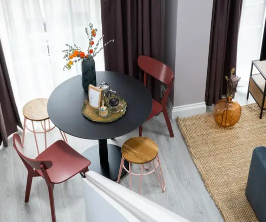 a living room with a table and chairs