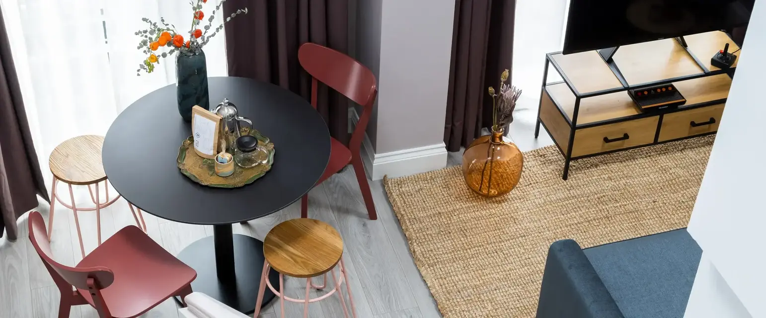 a living room with a table and chairs